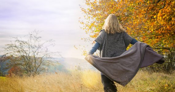 Woman outside in autumn dancing