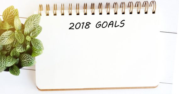 A note pad with 2018 goals written at the top in order to plan health goals