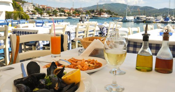 A restaurant table overlooking a harbour in france