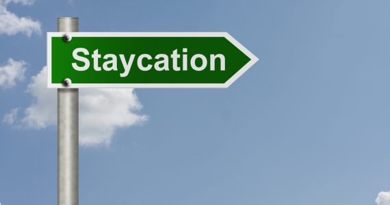 A road sign saying 'staycation'